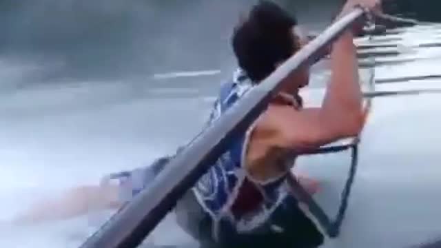 Guy holds onto bar speedboat face plant