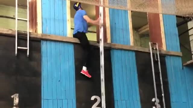 Competitive Firefighter Climbs Up Ladder