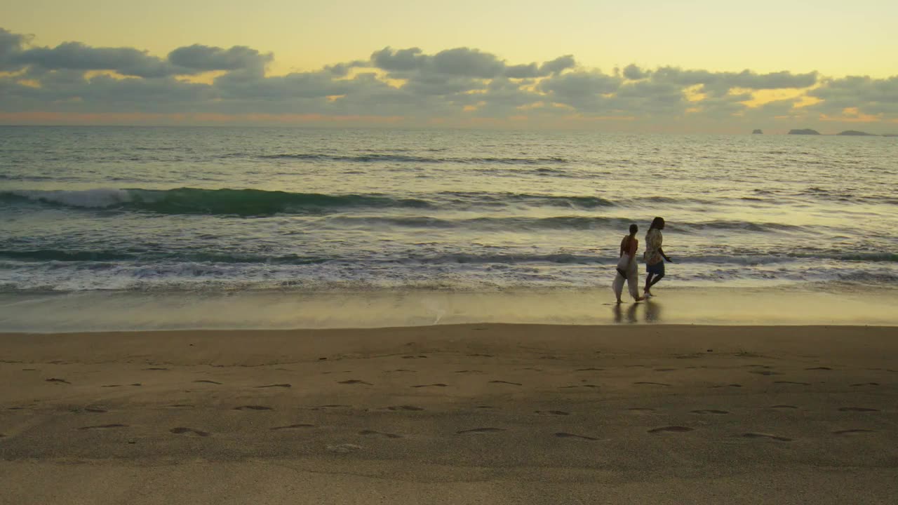 Couple enjoying a walk on the beach