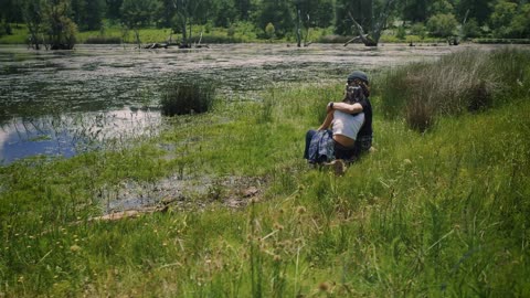 Loving couple sitting on the shore of a lake outdoors