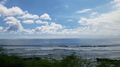 The sky is full of clouds. Drive right next to the sea.