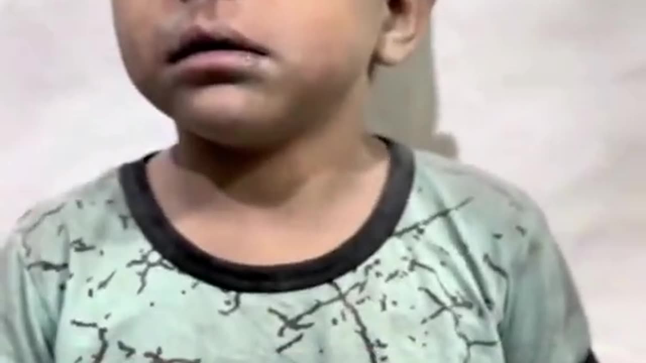 Doctor in Gaza tries to calm down a child shaking from fear due to Israeli airstrikes