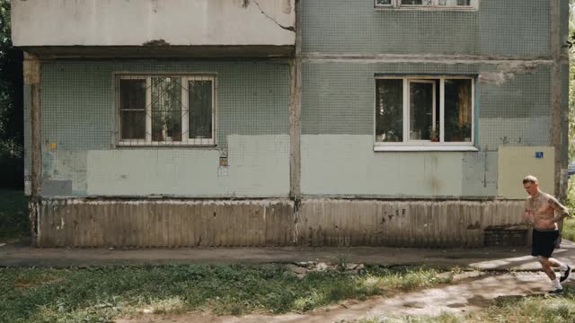 A Man Jogging In Front of an Old Building