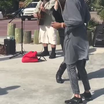 Woman with dog dances to i want to hold your hand