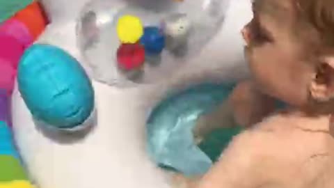 The baby swims in a new circle, in the pool