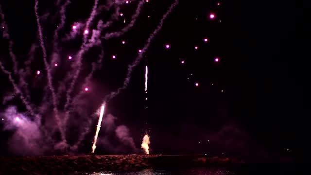 Fireworks rising from a pier