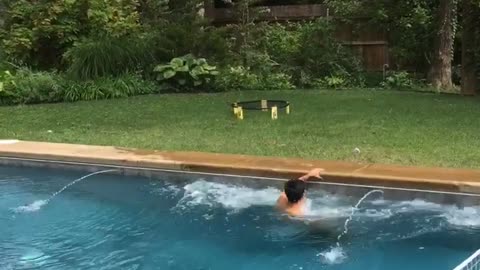 Guy tries to jump pool and hits stomach on other side