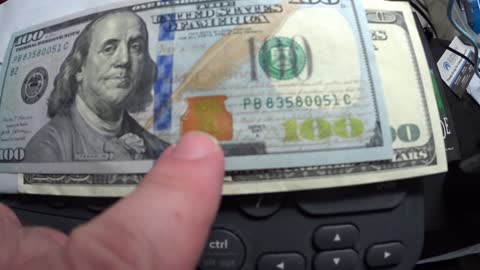 SHOWING THE DIFFERENCE BETWEEN AN OLD $100 BILL AND A NEW $100 BILL