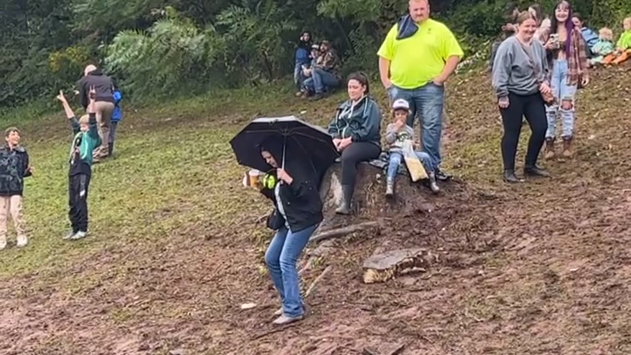 Woman Slips on Muddy Slope