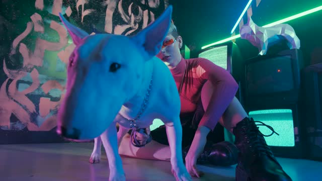 Woman in Cyberpunk Themed Outfit Sitting on the Floor with Dog