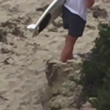 When you think you can surf but you're wearing shoes on the beach shirtless guy wears socks on the beach