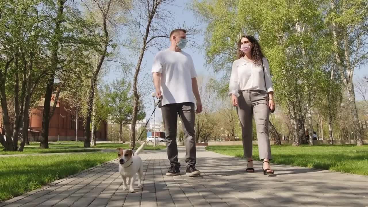 Handheld tracking with low angle of young man and woman