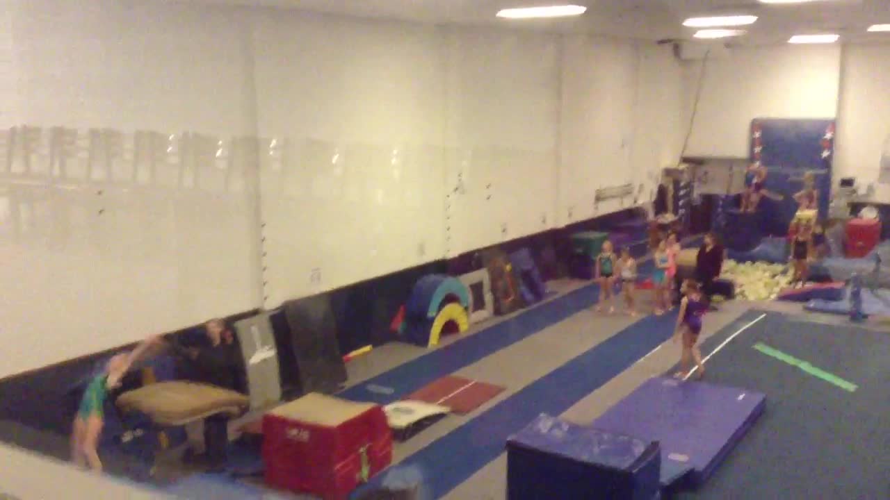 Girl in white trying to do flip falls down