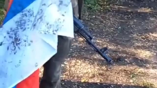 Ukrainian soldiers, clean their boots with, and rip up a recently captured Russian flag