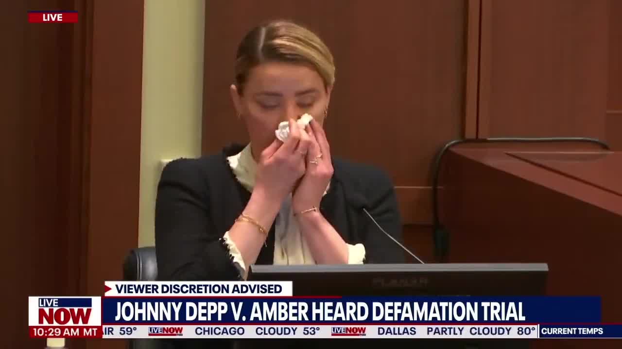 Amber Heard Appears to Pose For Picture, Wiping Away Tears