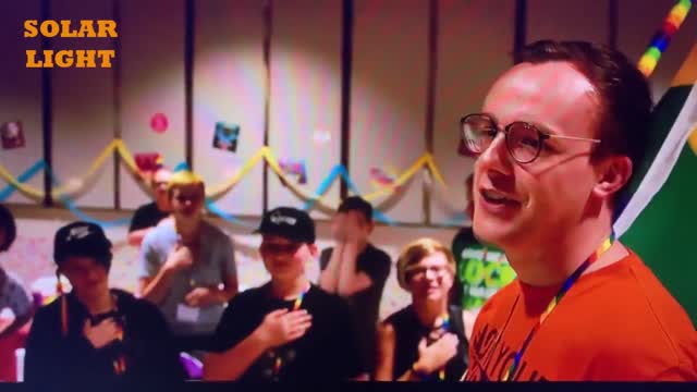 Chasten James Glezman Buttigieg Leads a Pledge to the Rainbow Flag with young people at a camp