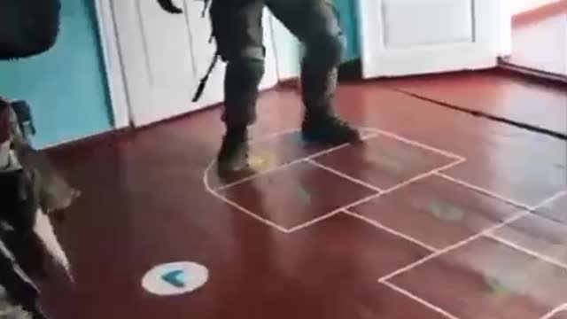 Ukraine soldier plays hopscotch inside children's school