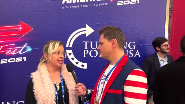 John Paul speaking with a reporter from the Tatum Report, at AmericaFest 2021