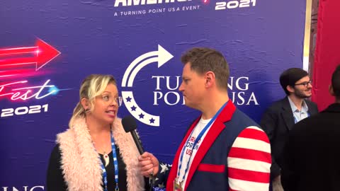 John Paul speaking with a reporter from the Tatum Report, at AmericaFest 2021