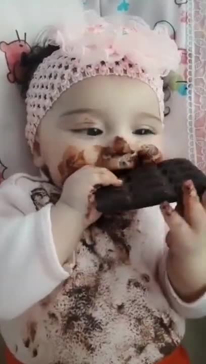 Cute baby eating chocolate