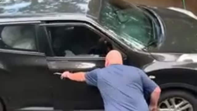 The brave man opened the car door to let the bear out