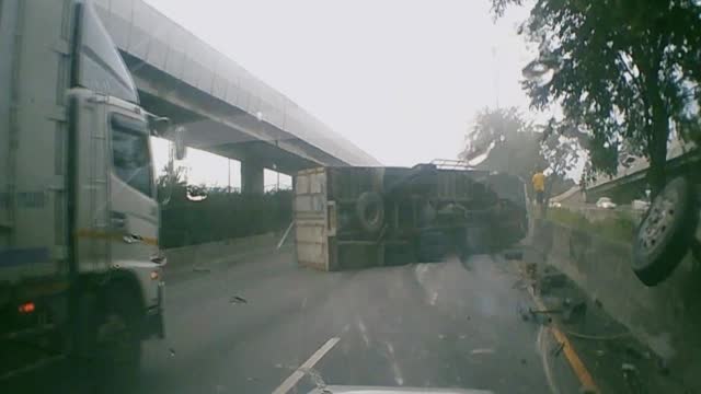 Truck Topples Over After Colliding With Barrier