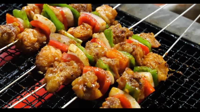 Vegetables and meat skewers in a barbecue, a special flavor