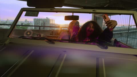 Friends taking a selfie in a car