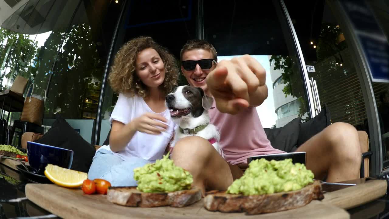 Happy Family Couple Taking Selfie With Dog In Cafe