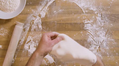 Top View Male Hand Stretching Dough