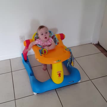 Baby in walker toy play