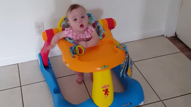 Baby in walker toy play