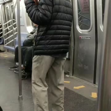 Old man hat plays wooden flute on subway