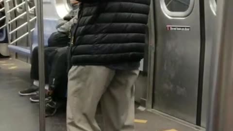 Old man hat plays wooden flute on subway