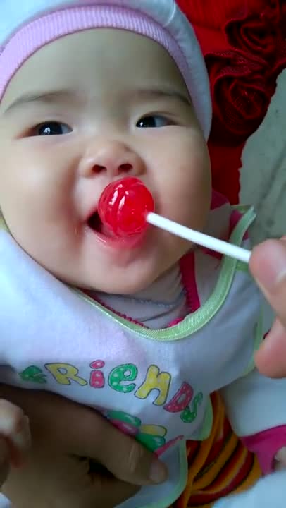 Baby eating candy is cute and funny