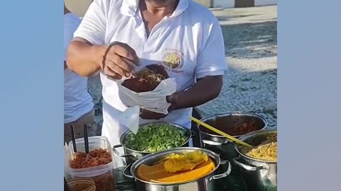 Acarajé (a type of sandwich made with bean dough) in the streets of Salvador, Bahia, Brazil