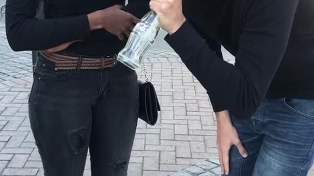 The magician broke the bottle, and the people next to him were dumbfounded