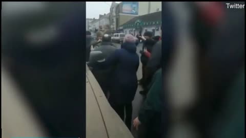 Russian Walking Through a Crowd of Ukrainians Holding These in His Hands!