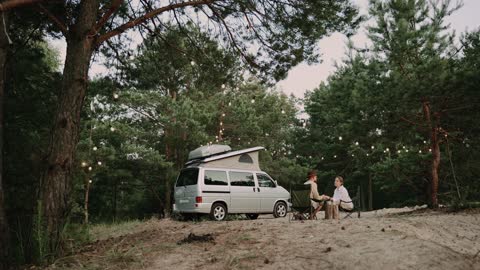 A Couple Sitting on a Campsite