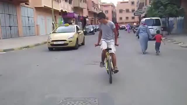 Boy cycling backward direction