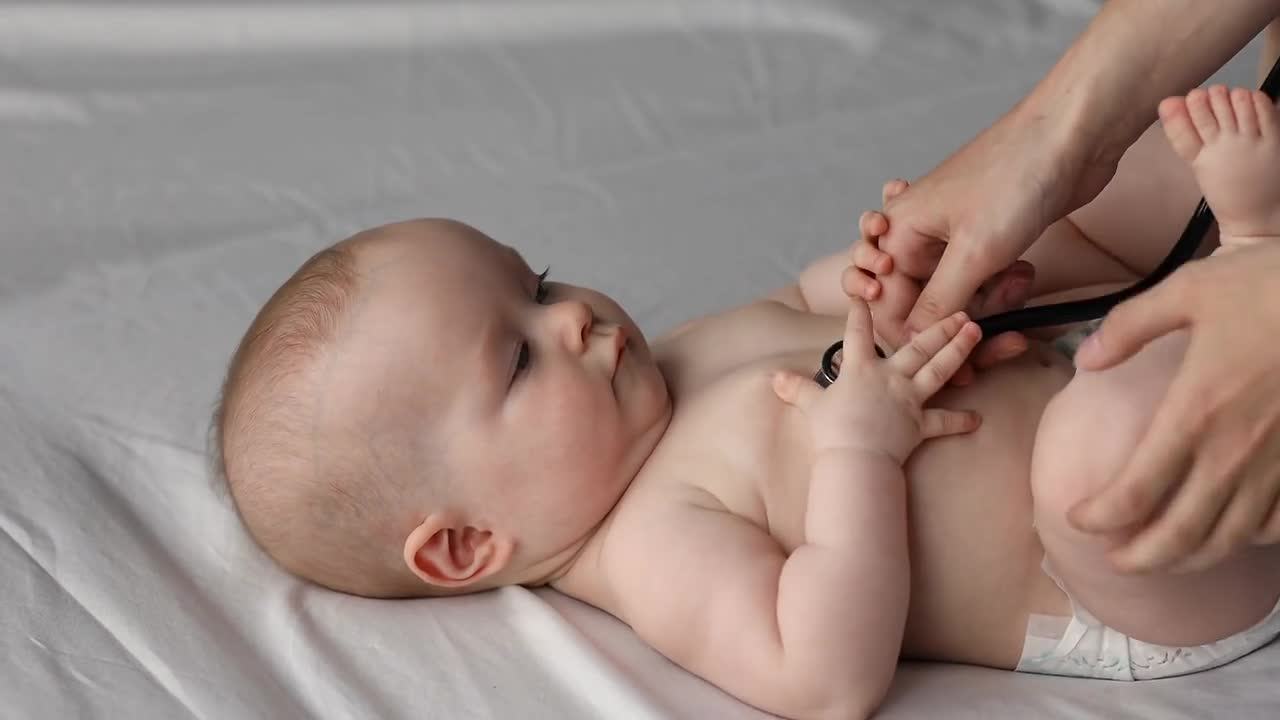 Pediatrician hold stethoscope check heartbeat rate of little baby kid