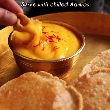 "The Irresistible Delight: Aamras Puri - A Divine Pairing of Mango Puree and Fluffy Deep-Fried Bread!"