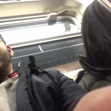 Woman next to man taking selfie keeps falling asleep on subway