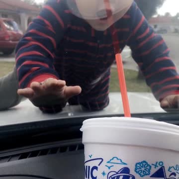 Toddler Tries To Drink Soda Through Car Windshield