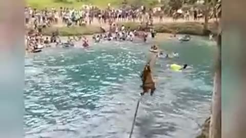 People playing in water on the bridge in Spain.