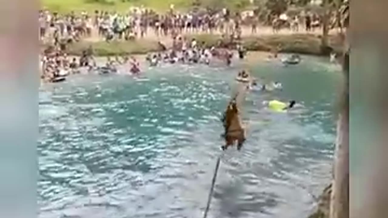 People playing in water on the bridge in Spain.