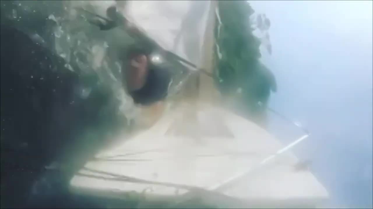 Guy Gets Shoved off Board by Sail While Windsurfing