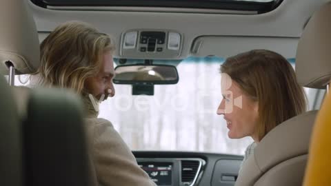 Happy Friends Sitting In A Car Talking And Laughing Together 1