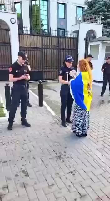 Pro-Ukrainian protestors pour water at the Russian Embassy in Moldova