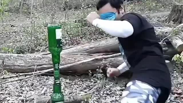 Man kicks CD From Between Two Bottles While in Blindfold